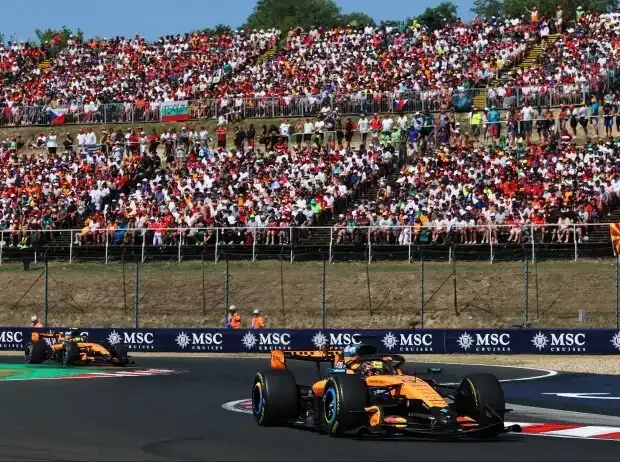 Title image for the news: Oscar Piastri and Lando Norris in front of packed grandstands in Hungary 2026