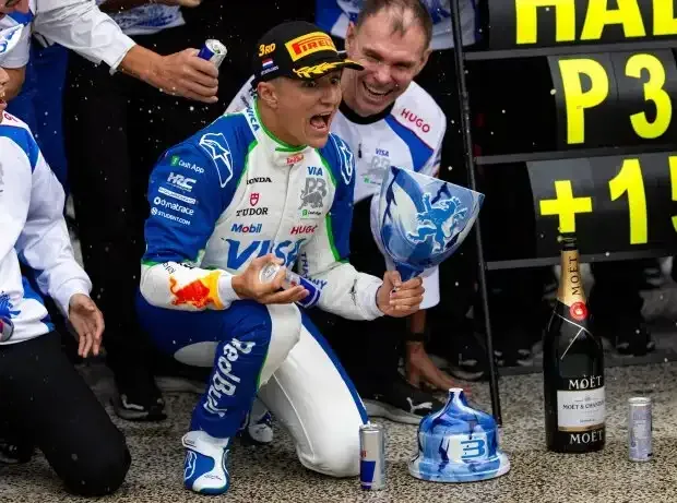 Title image for the news: Isack Hadjar (Racing Bulls) and the damaged trophy after third place at the Formula 1 race in Zandvoort 2025