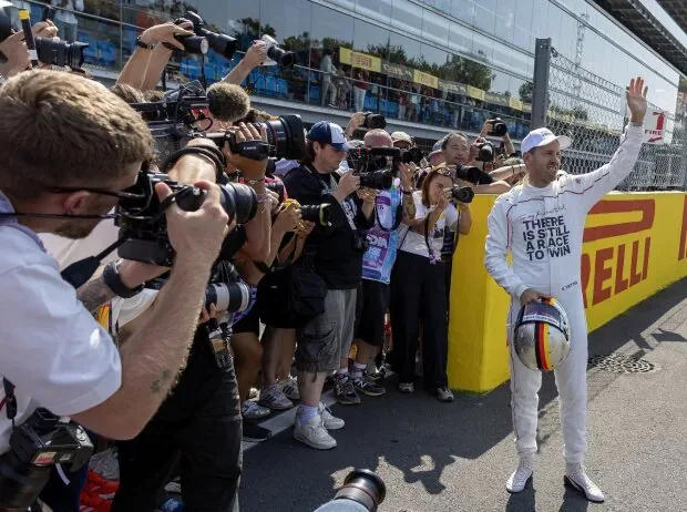 Sebastian Vettel surrounded by photographers during his demo laps in Monza 2026